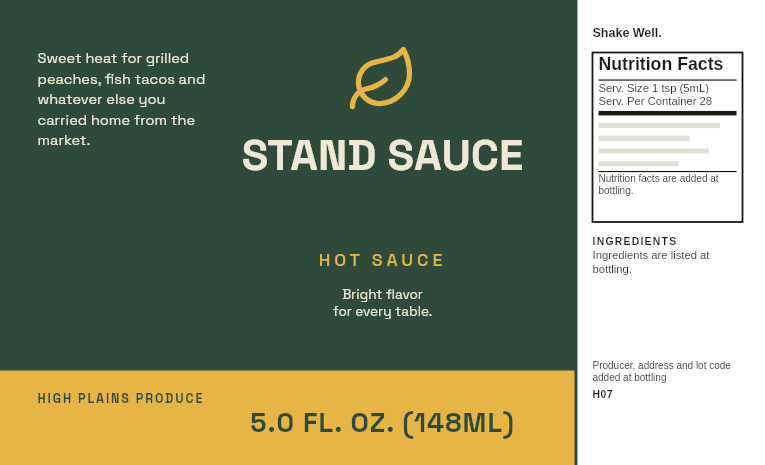 Produce stand label “Stand Sauce” on a 5 oz mango pineapple hot sauce bottle